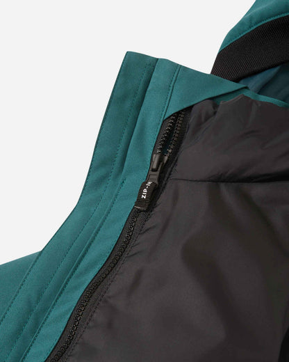 Close-up detail of the internal zip-in system on the Reima Syddi jacket, showing how the black quilted inner jacket easily attaches to the dark teal outer shell.