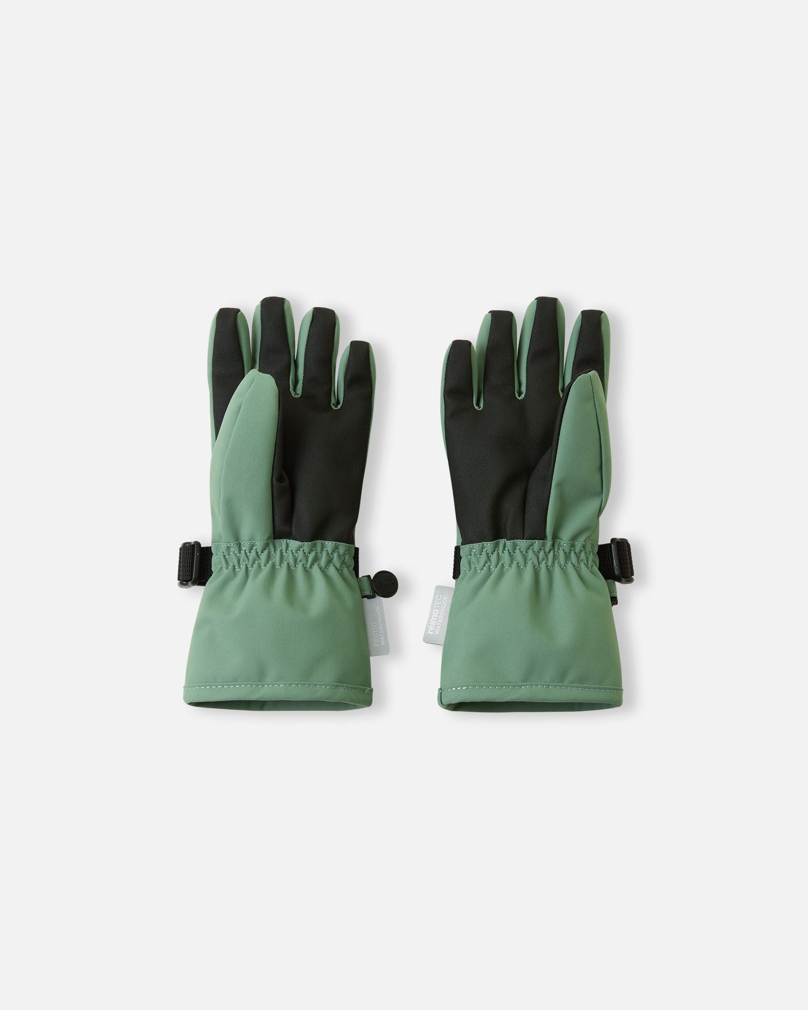 Flat lay view of the palms of the green clay Reima Tartu kids' winter gloves. The image showcases the durable black reinforced gripping surface on the palms and fingertips, engineered for flexibly holding ski poles.