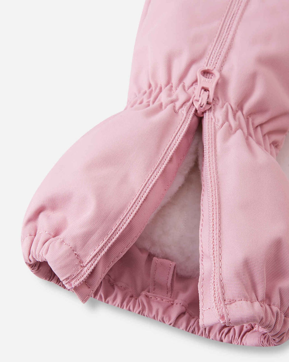 Close-up macro detail of the opened zipper on the grey pink Reima Tassuin toddler mittens, revealing the warm and soft wool-mix pile interior lining.