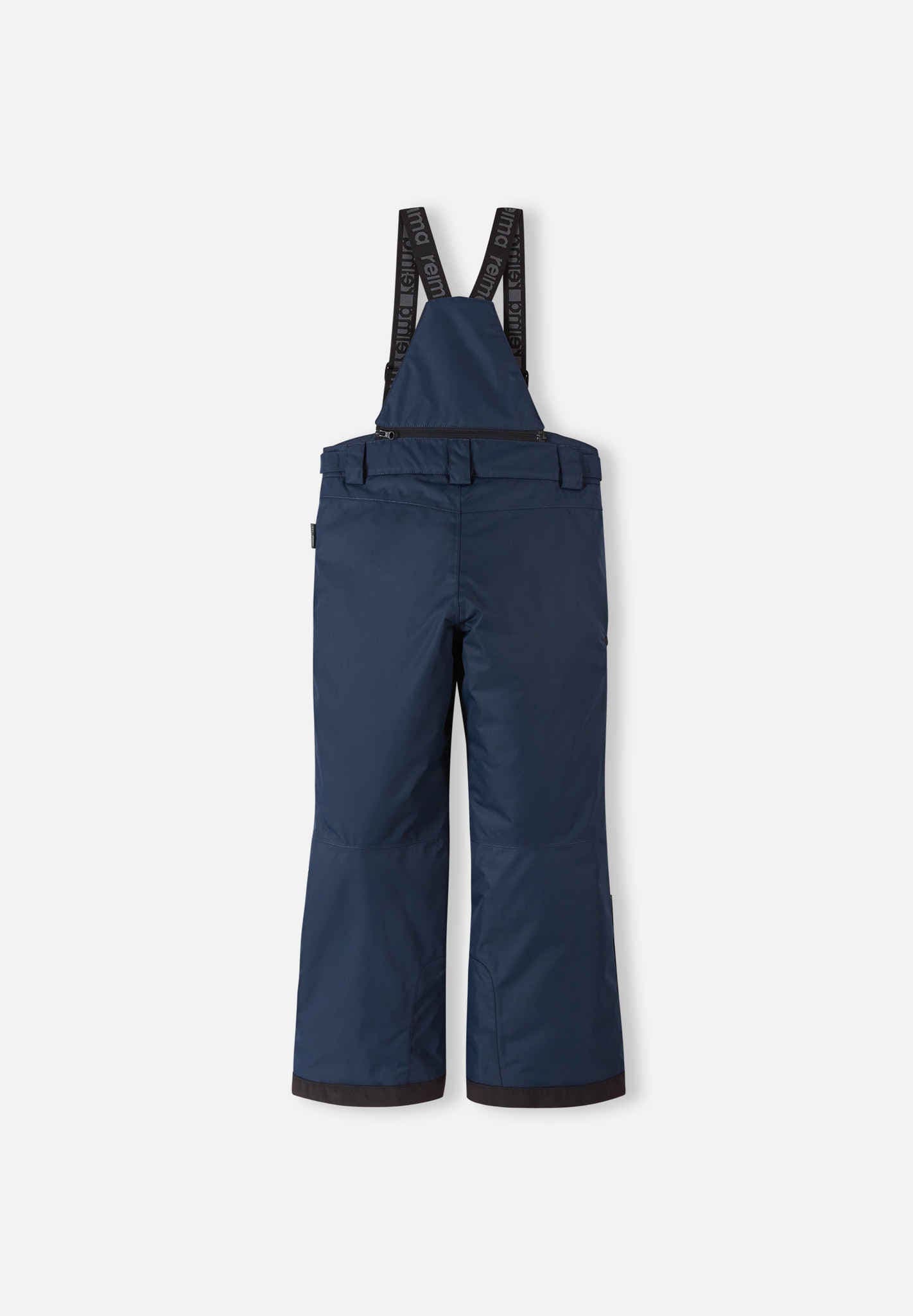 Back flat lay view of the navy blue Reima Terrie kids' ski pants, showcasing the high-back coverage, elastic waistband, and heavy-duty black reinforced lower legs built for rugged winter sports.