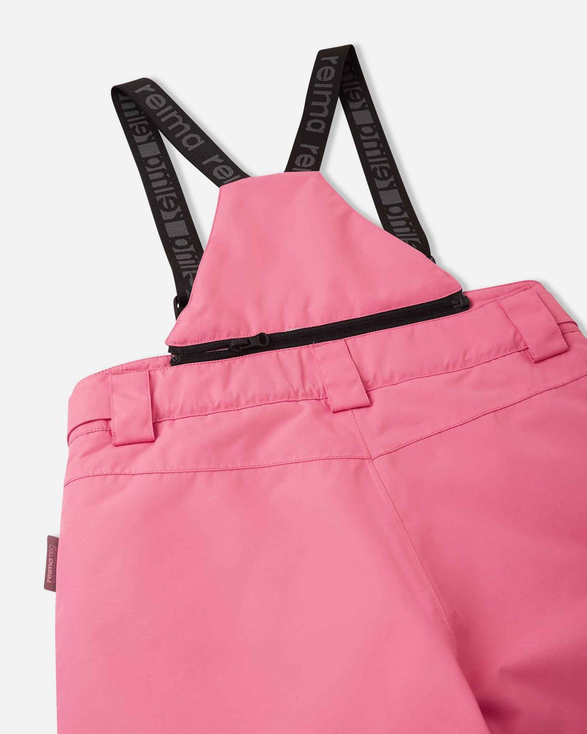 Detail view of the upper back on the soft coral Reima Terrie kids' snow pants, featuring the stretchy high-back panel for extra core warmth, belt loops, and sturdy Reima-branded elastic suspenders.