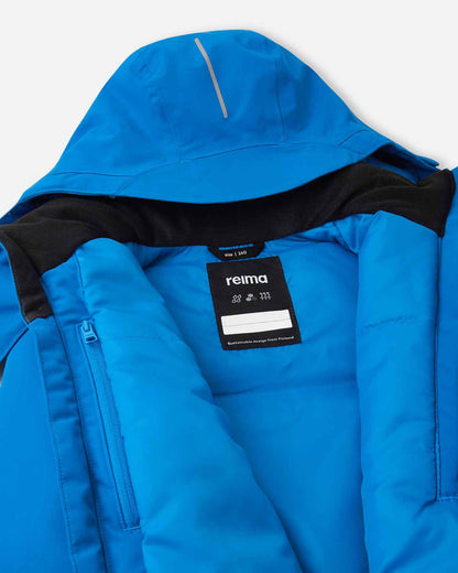 Inner collar shot of the bright blue Reima Tieten boys' alpine coat, showcasing the smooth dark lining, Reima performance tag, and a blank name label for easy identification at ski school.