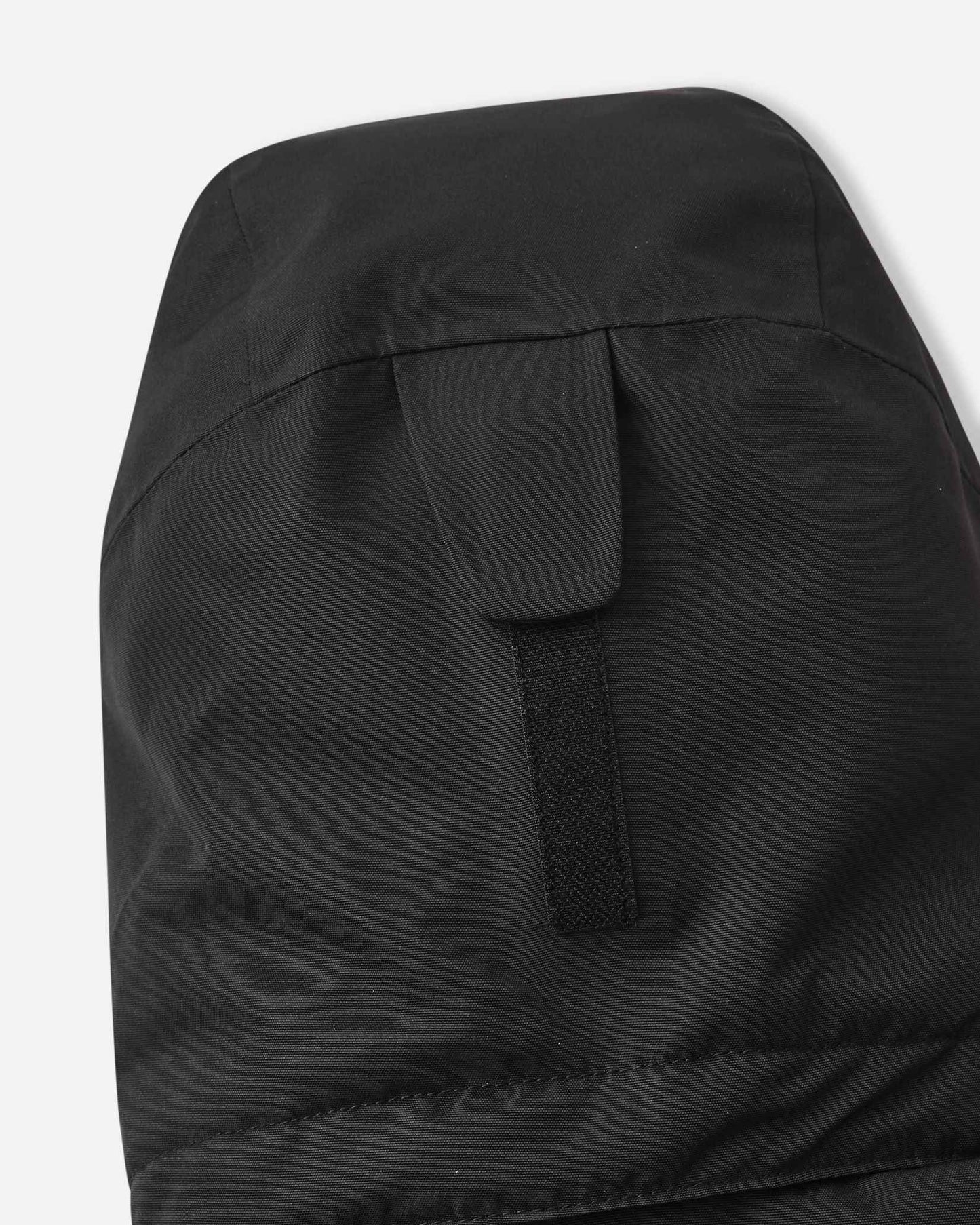 The back of the black Reima Tieten winter jacket features a large hood to protect children from wind and snow.