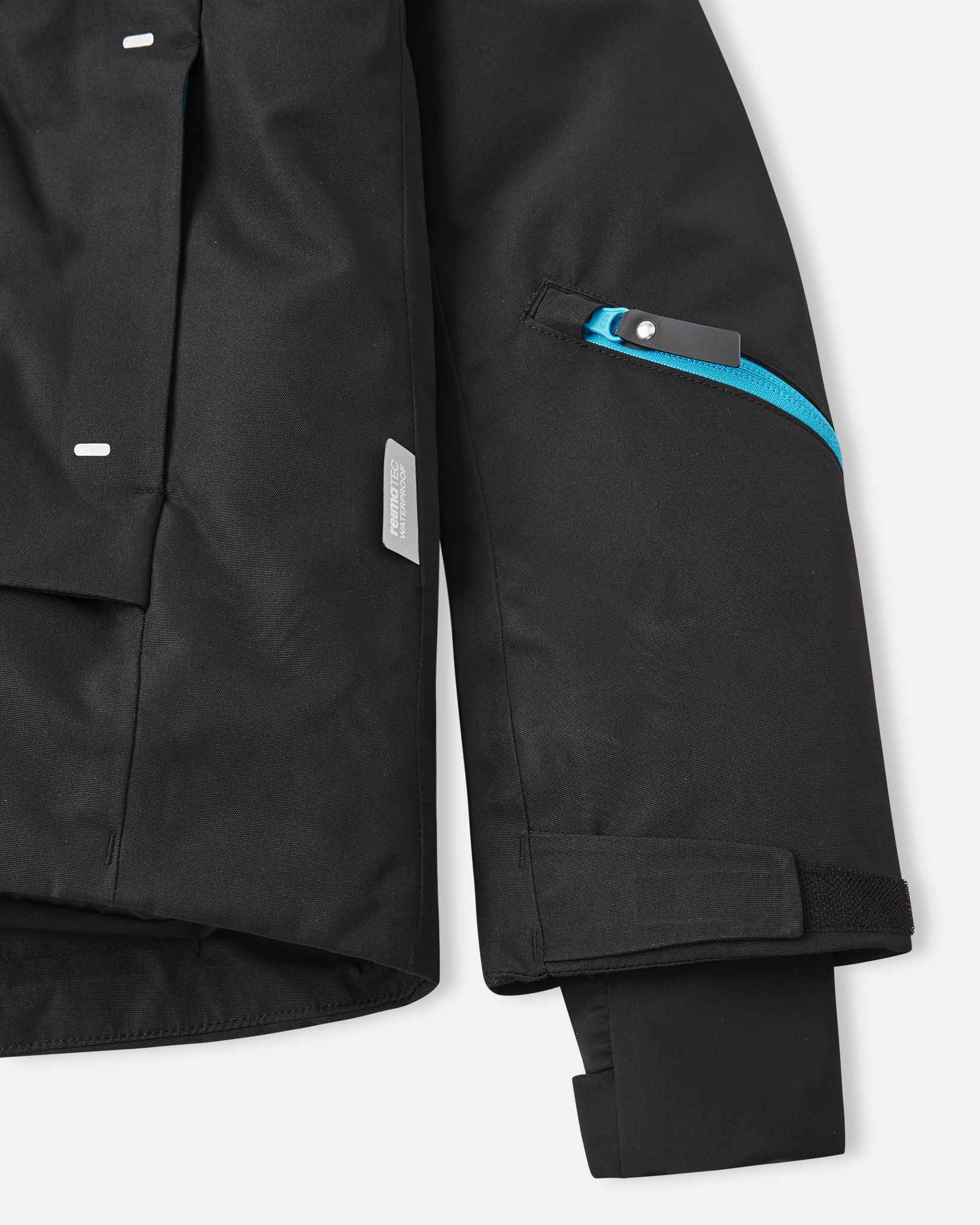 Contrasting bright blue zippers stand out against the solid black fabric on the front of this children's winter coat.