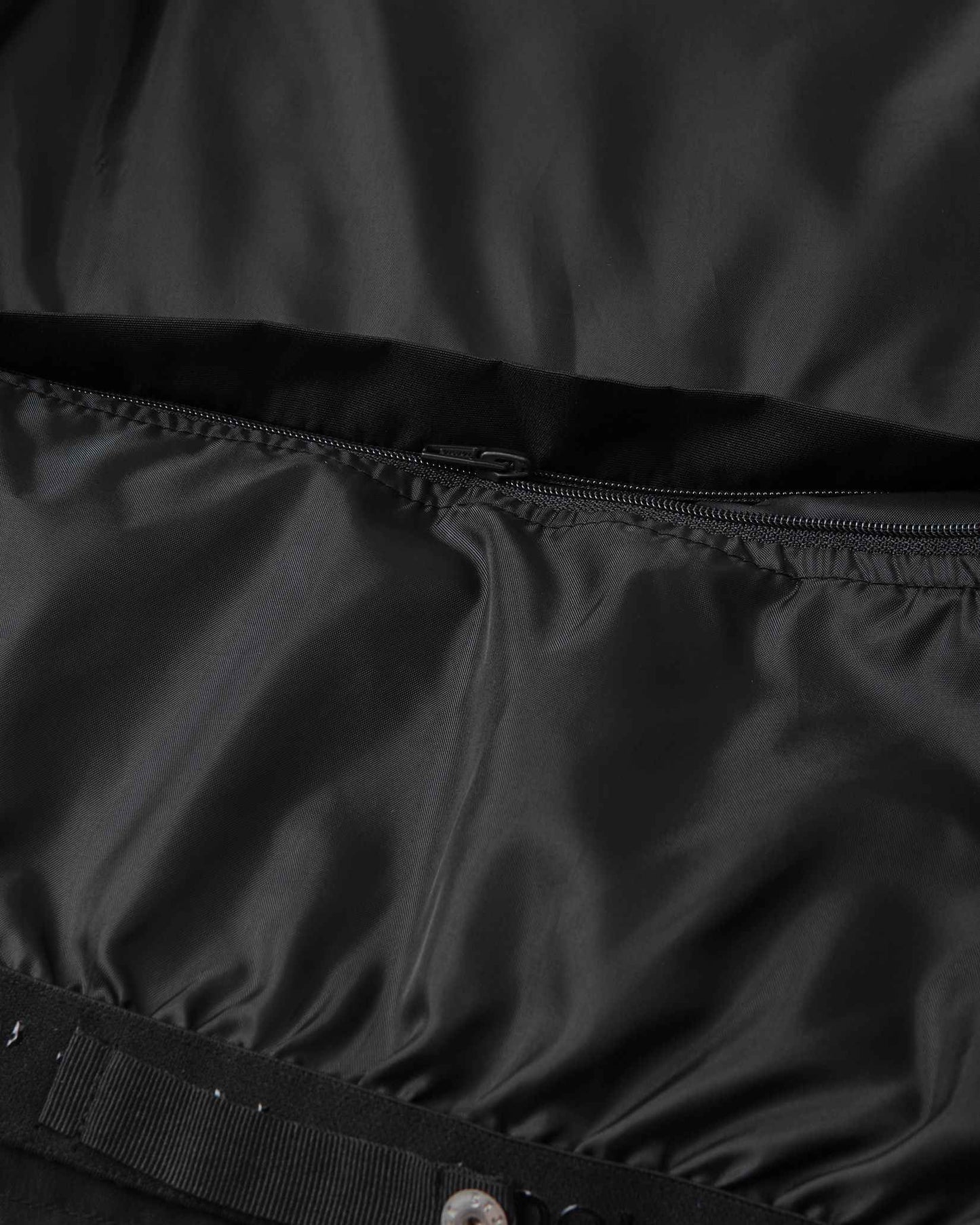 A close view of the lower back and waist section shows the durable construction of the black Tieten snow jacket.