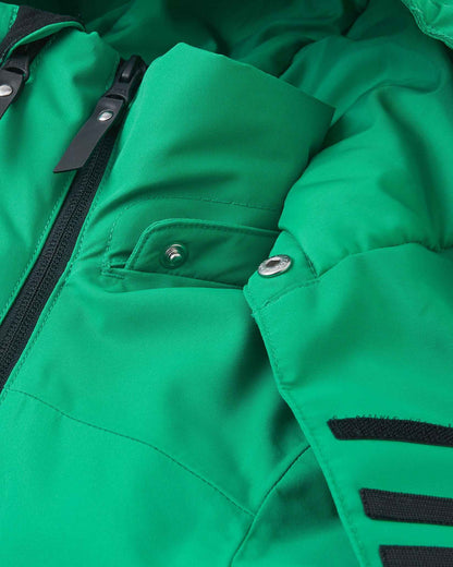 A close view of the green Reima Tieten kids ski jacket shows the front zipper securely closed near the neck to block cold wind.
