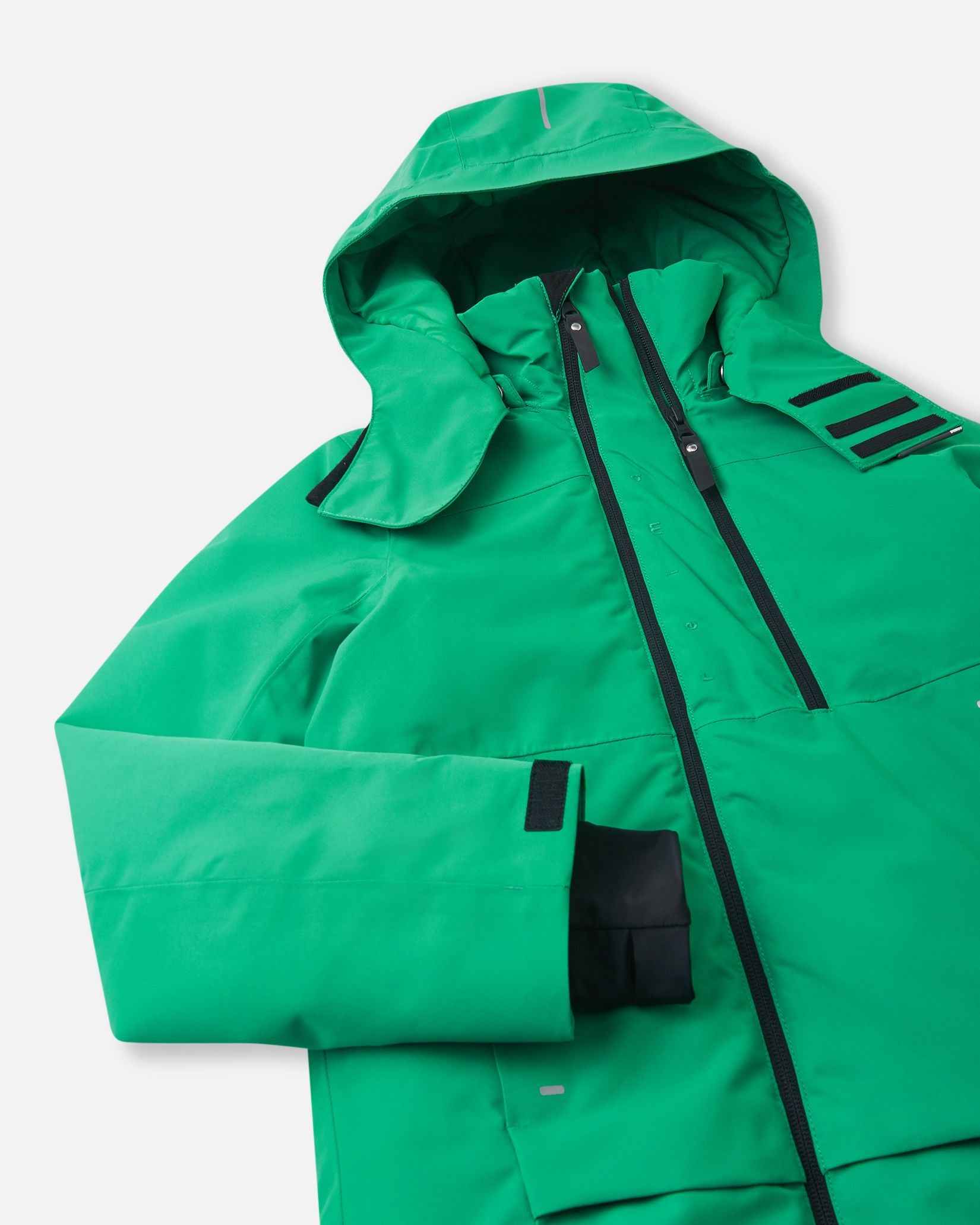 A side view of the green Reima winter coat highlights the shaped hood and adjustable sleeve cuffs.