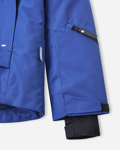 An internal black protective snow skirt sits near the bottom hem of the blue winter jacket.