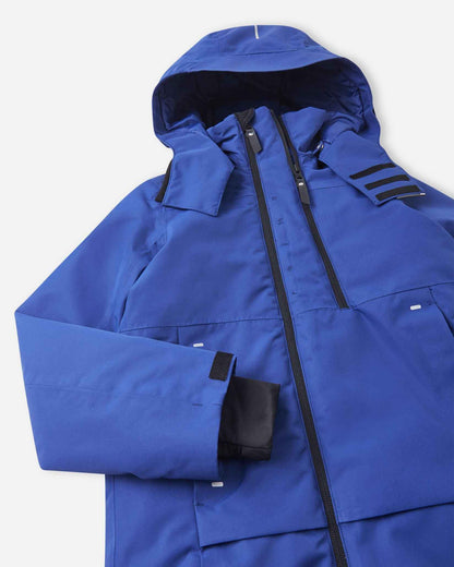 A profile angle of the blue kids snow jacket shows the fitted hood shape and black cuff adjusters.
