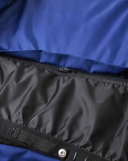 Metal snap buttons secure the black inner lining inside the blue Reima ski jacket.