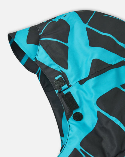 Close-up of the secure velcro hood attachment system on the back collar of the black Reima Tirro kids' waterproof winter ski jacket.