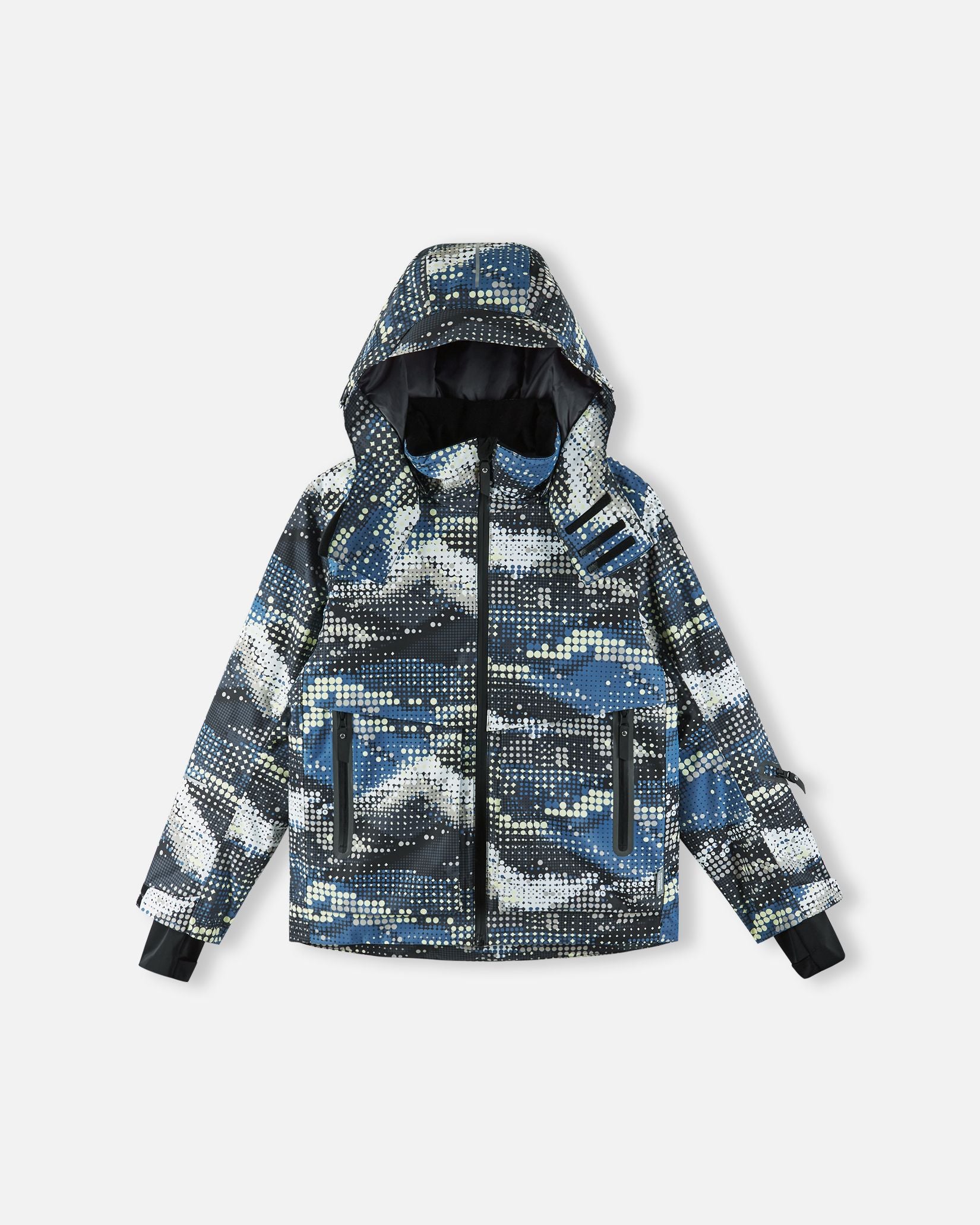 Front flat lay view of the soft black Reima Tirro kids' waterproof ski jacket, featuring a digital dot camouflage pattern, a helmet-compatible hood, and secure waterproof zippered pockets.