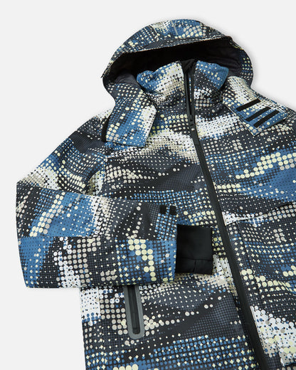 Angled close-up of the upper chest, hood, and sleeve on the soft black Reima Tirro kids' waterproof ski jacket, showcasing the digital dot pattern and sealed front zipper.