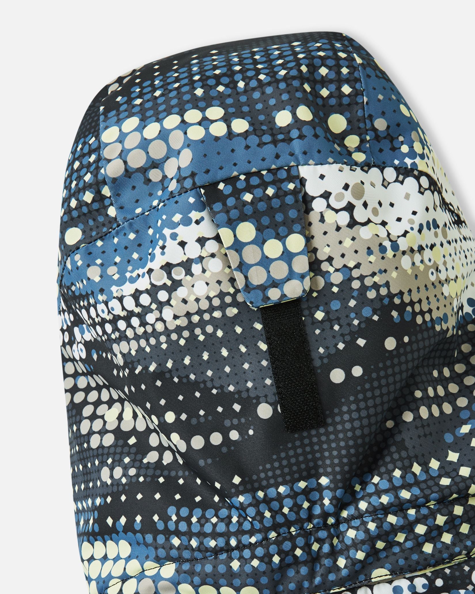Close-up view of the rear velcro adjustment strap on the helmet-compatible hood of the soft black Reima Tirro kids' waterproof ski jacket.