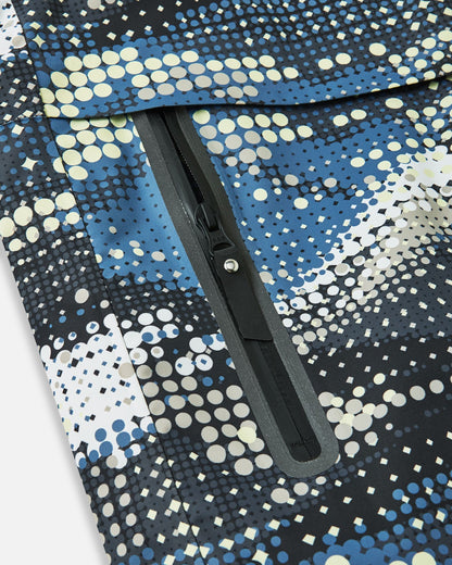 Detailed close-up of the sealed, water-resistant zipper pocket on the front panel of the soft black Reima Tirro kids' winter ski jacket.