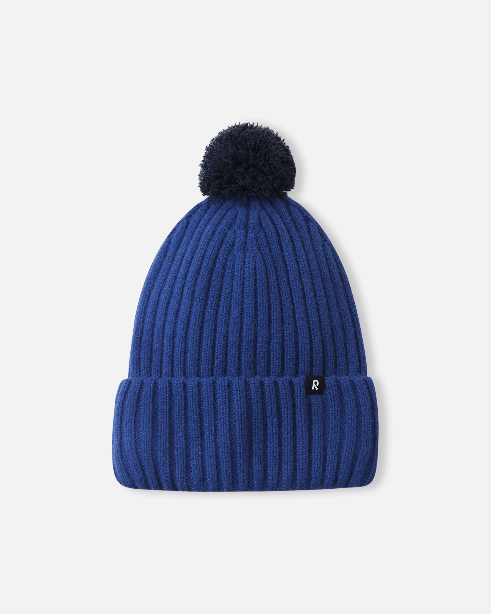 Alternate front flat lay view of the twilight blue Reima Topsu children's wool blend beanie, showcasing the thick folded brim, the small black Reima logo tag, and the warm winter-ready construction.