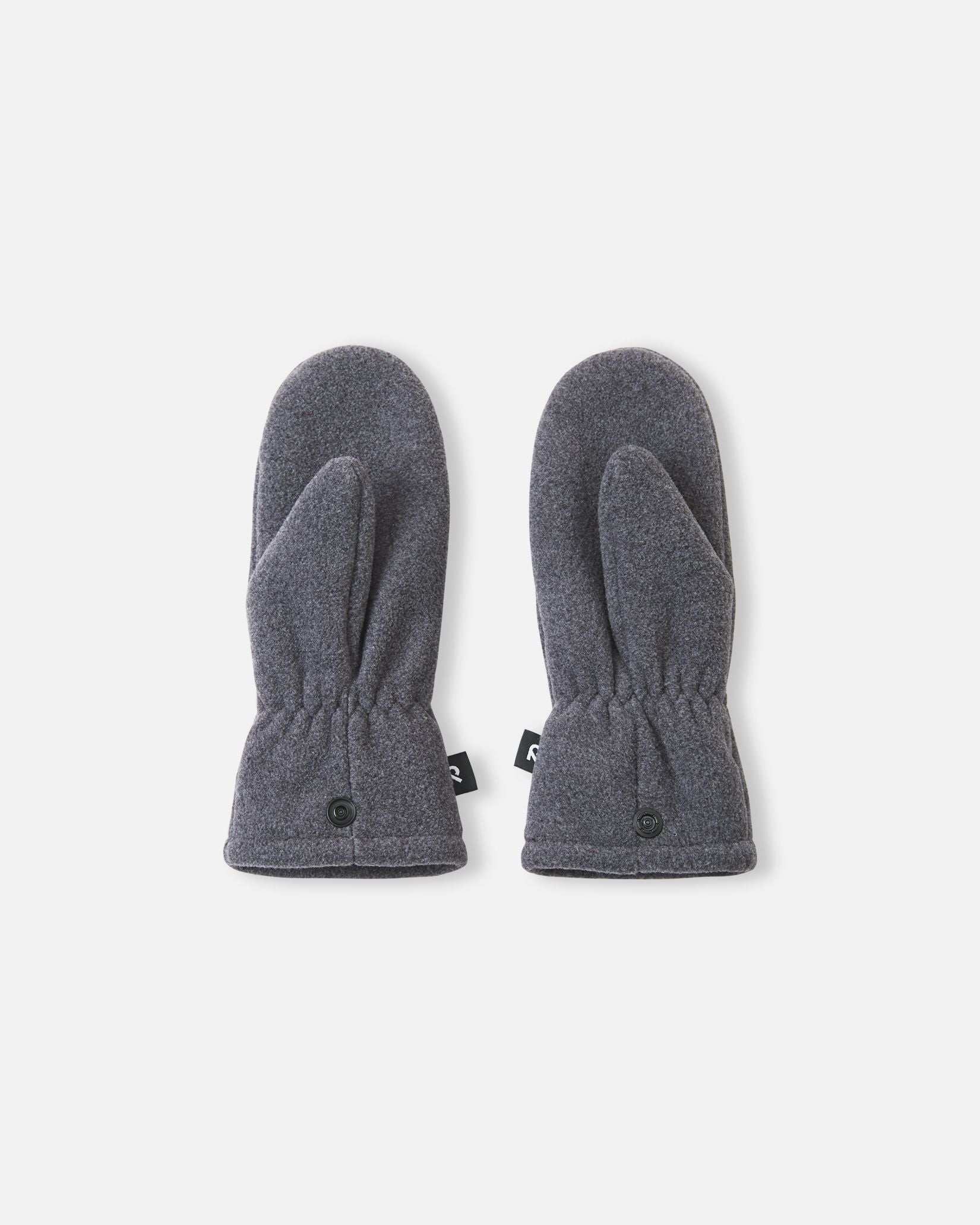 Flat lay view of the palms of the black melange Reima Tumpus kids' fleece mittens, showing the ergonomic thumb construction and practical snap fasteners at the cuffs.