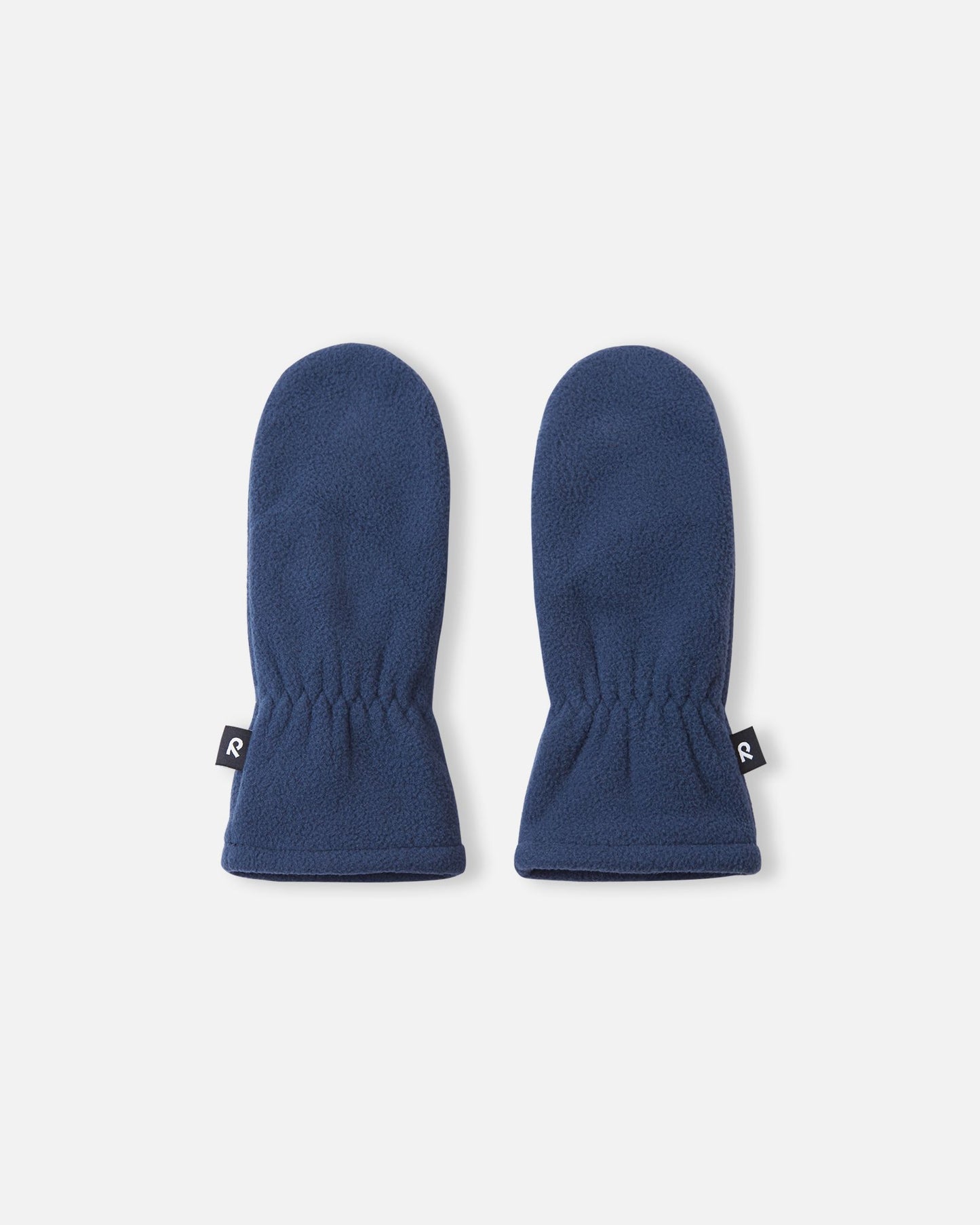 Flat lay view of the backs of the navy blue Reima Tumpus kids' fleece mittens, showcasing the soft texture and elastic wrists for comfortable everyday winter wear.