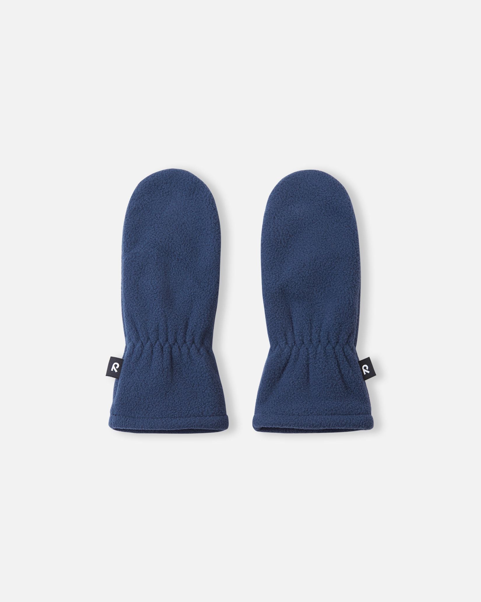 Flat lay view of the backs of the navy blue Reima Tumpus kids' fleece mittens, showcasing the soft texture and elastic wrists for comfortable everyday winter wear.