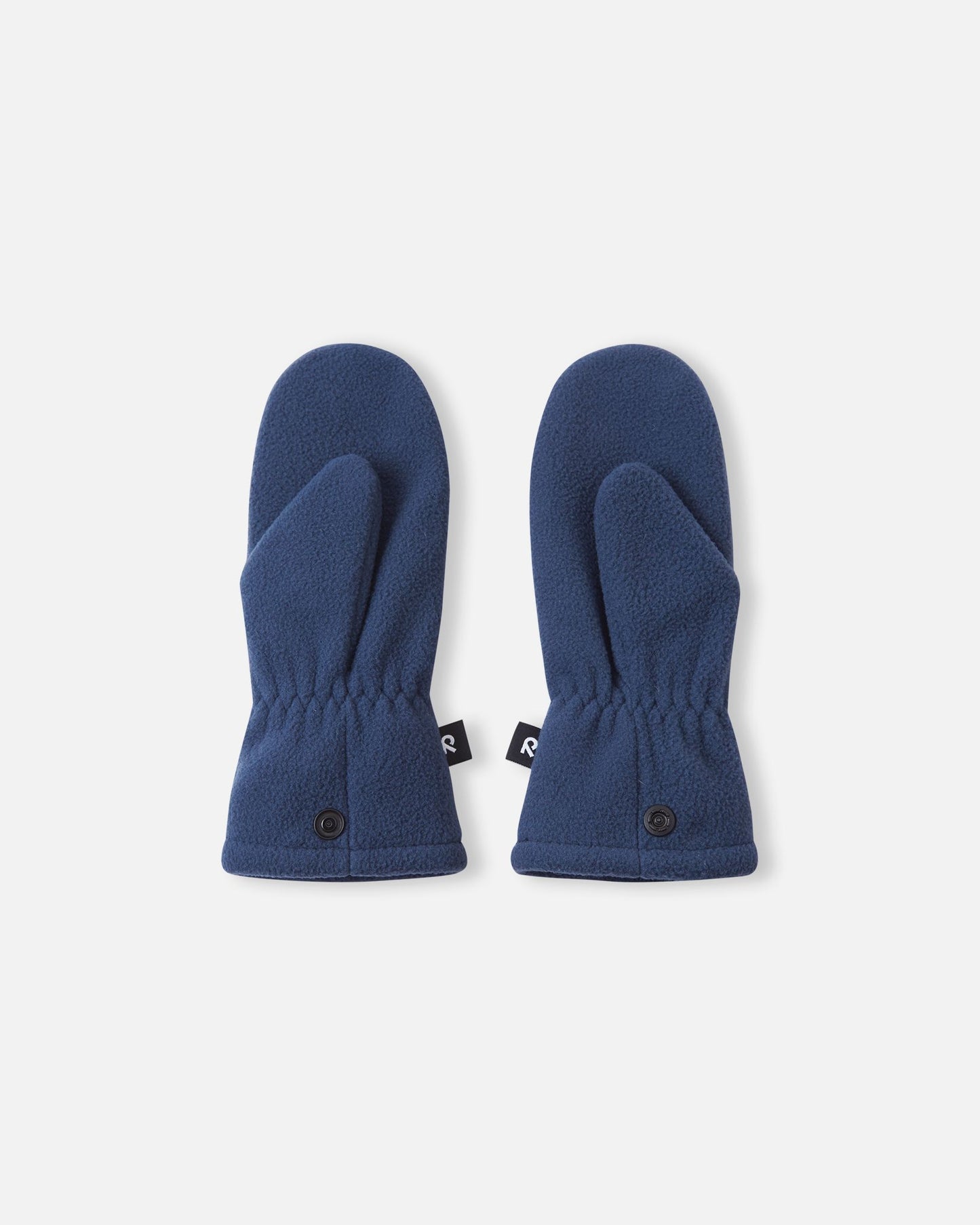 Flat lay view of the palms of the navy blue Reima Tumpus kids' fleece mittens, featuring the functional thumb shape and snap attachments on the lower cuffs.