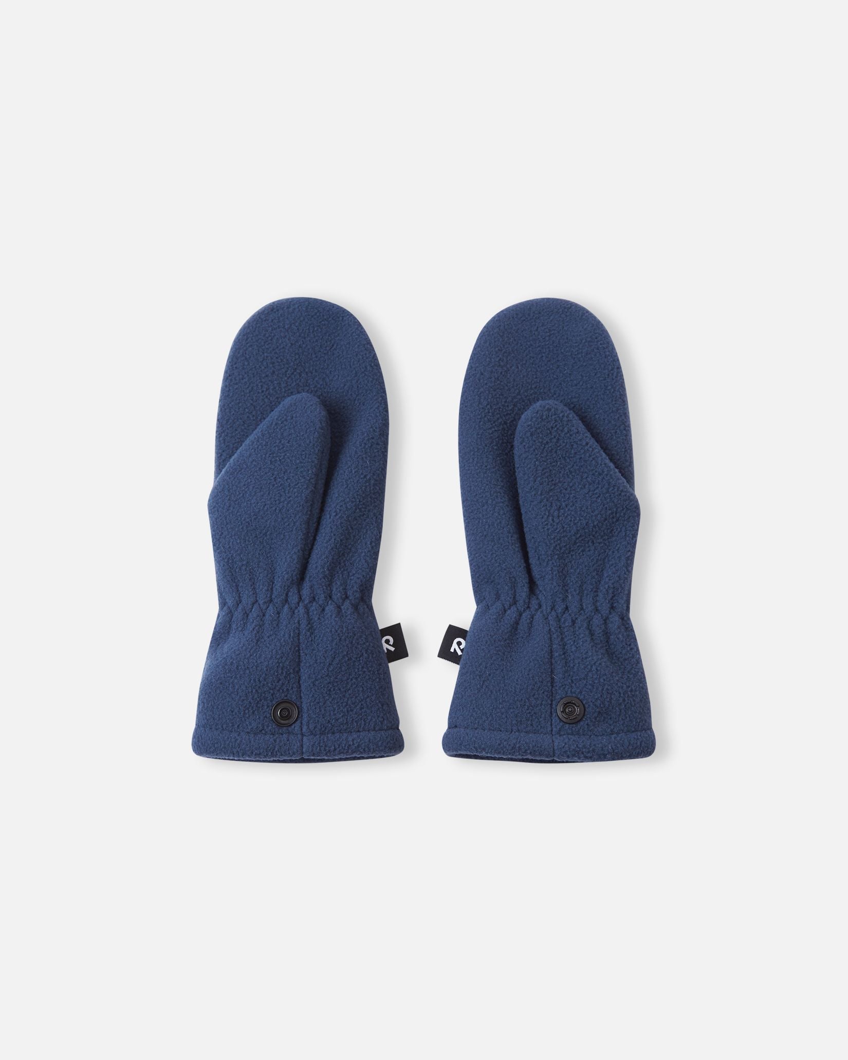 Flat lay view of the palms of the navy blue Reima Tumpus kids' fleece mittens, featuring the functional thumb shape and snap attachments on the lower cuffs.