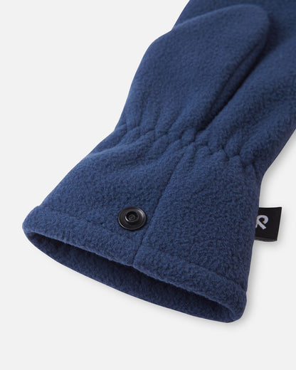 Detailed close-up of the gathered elastic wrist and snap button fastening system on the navy blue Reima Tumpus kids' cozy fleece mitten.