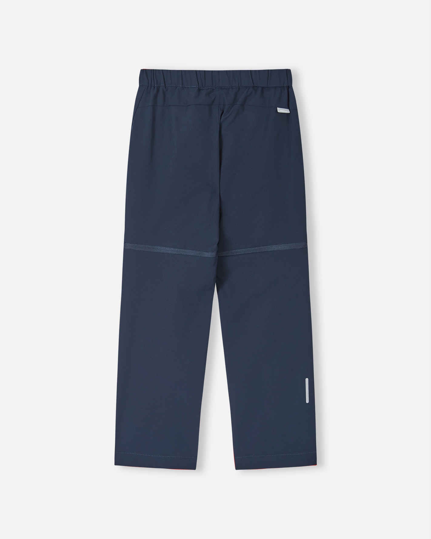 Back view of the navy blue Reima Tuplat kids' convertible hiking pants, displaying the smooth, durable outdoor construction, clean seat design, and a highly visible reflective safety strip on the lower calf.
