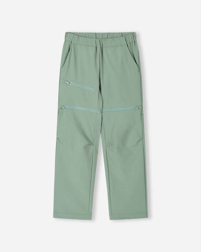Front view of the Reima Tuplat kids' convertible hiking pants in stone green, featuring a comfortable elastic waist, a zippered thigh pocket, and discrete zip-off legs to easily convert into summer shorts.