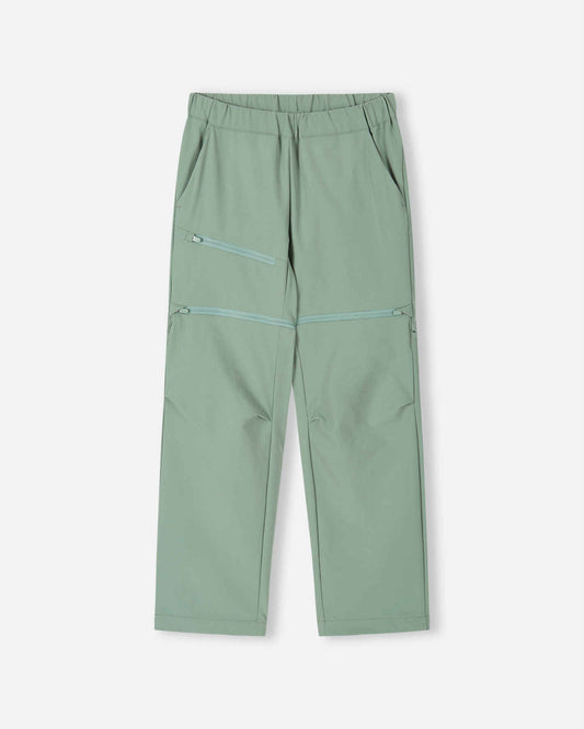 Front view of the Reima Tuplat kids' convertible hiking pants in stone green, featuring a comfortable elastic waist, a zippered thigh pocket, and discrete zip-off legs to easily convert into summer shorts.