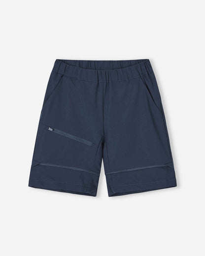 Front view of the Reima Tuplat kids' hiking pants converted into navy blue shorts, showing the comfortable athletic cut, deep side pockets, and secure zippered cargo pocket ideal for summer trail exploration.
