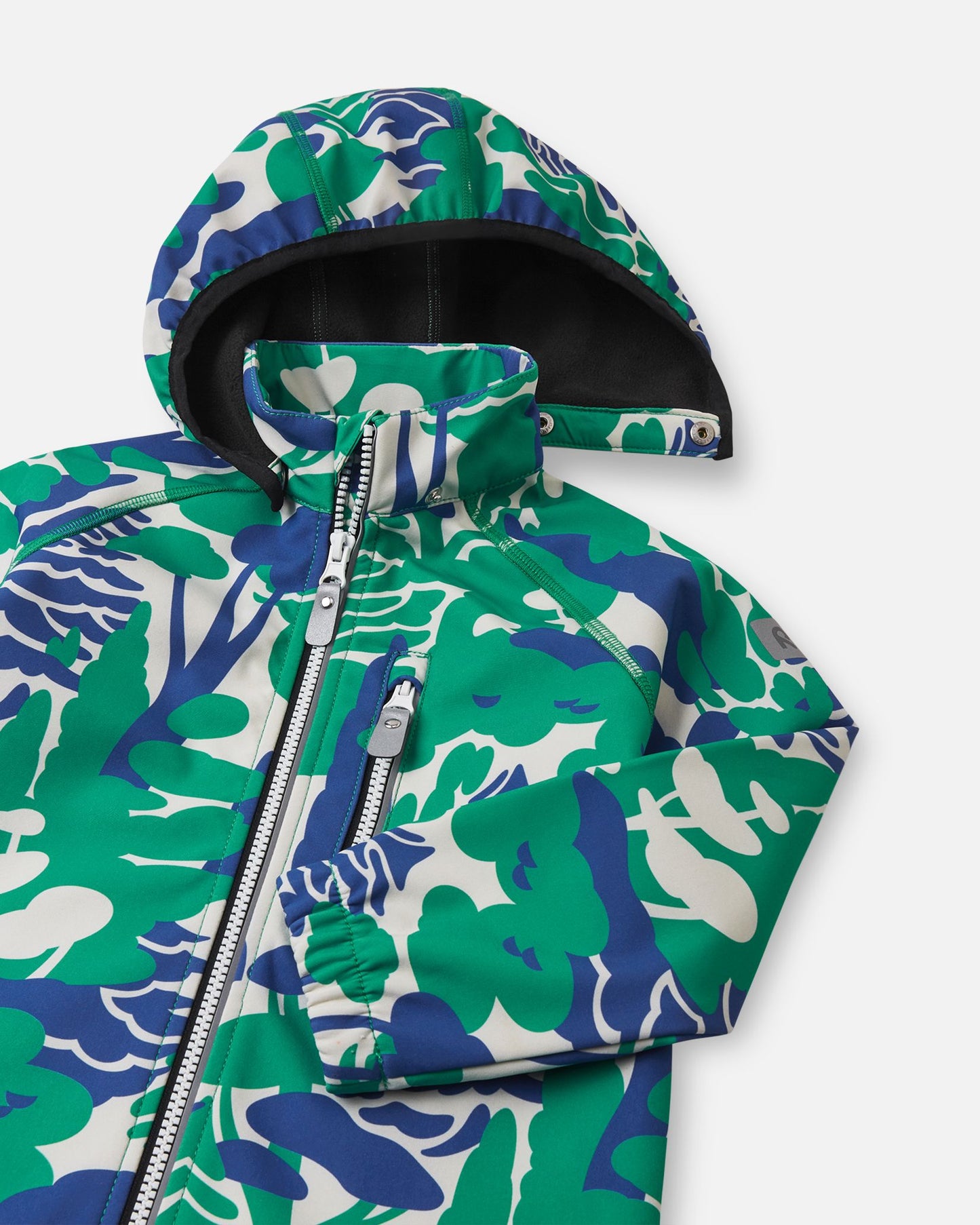 Close-up of the hood and high collar on the green forest print Reima Vantti kids' softshell jacket, showing the cozy, insulating black fleece lining designed to provide warmth during transitional weather.