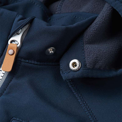 Close-up of the secure snap buttons on the collar of the Reima Vantti kids' softshell jacket, illustrating the child-safe detachable hood mechanism designed to easily pop off if caught.