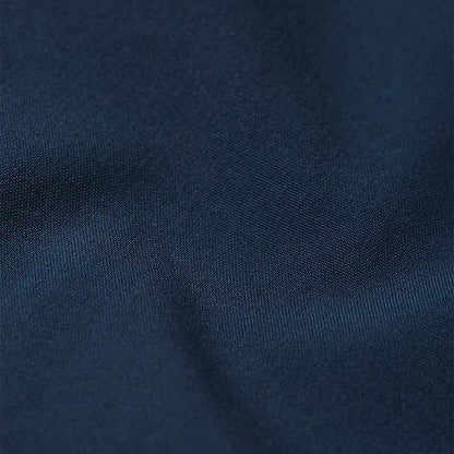 Macro texture detail of the navy blue Reima Vantti kids' softshell jacket, showing the tightly woven, dirt-repellent, and windproof outer shell material.