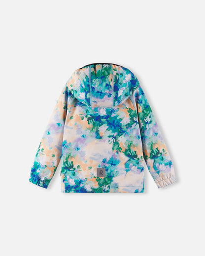 Back view of the fresh blue floral Reima Vantti kids' softshell jacket, showcasing a comfortable active fit, a protective hood, and a highly visible reflective safety patch at the lower hem.