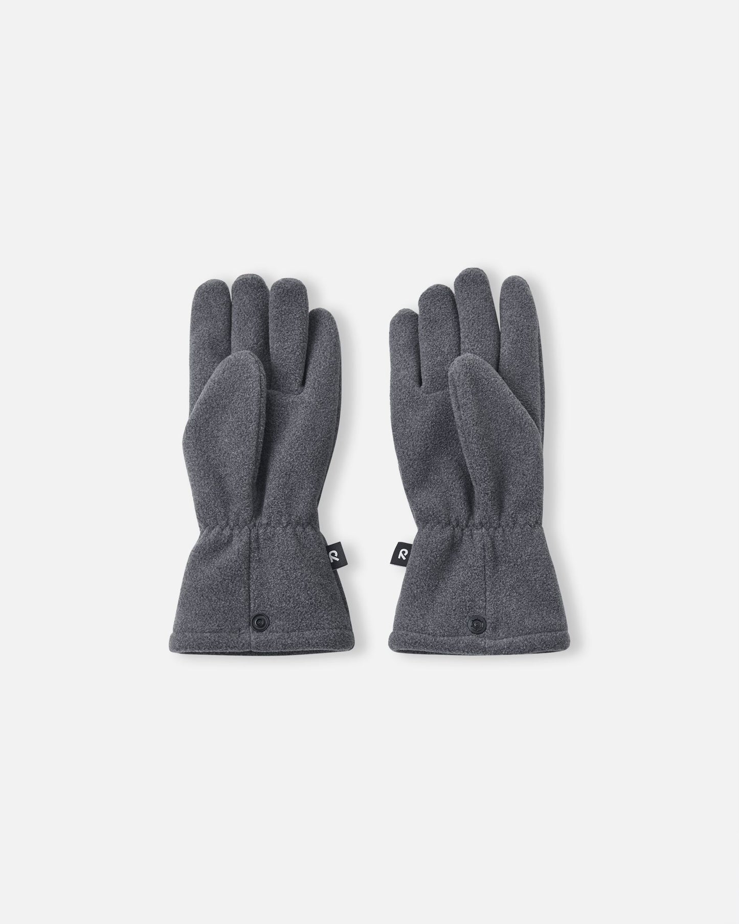 Palm side view of the Reima Varmin children's fleece gloves in a dark grey black melange, featuring a comfortable five-finger design, gathered wrists to keep out cold drafts, and connecting snap buttons at the hem.