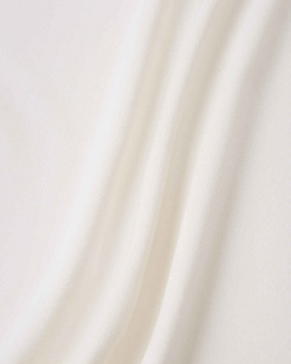 Macro close-up of the lightweight, breathable cooling fabric used in the Reima Vauhdikas kids' summer t-shirt in off-white, highlighting its soft, comfortable, and moisture-wicking texture.