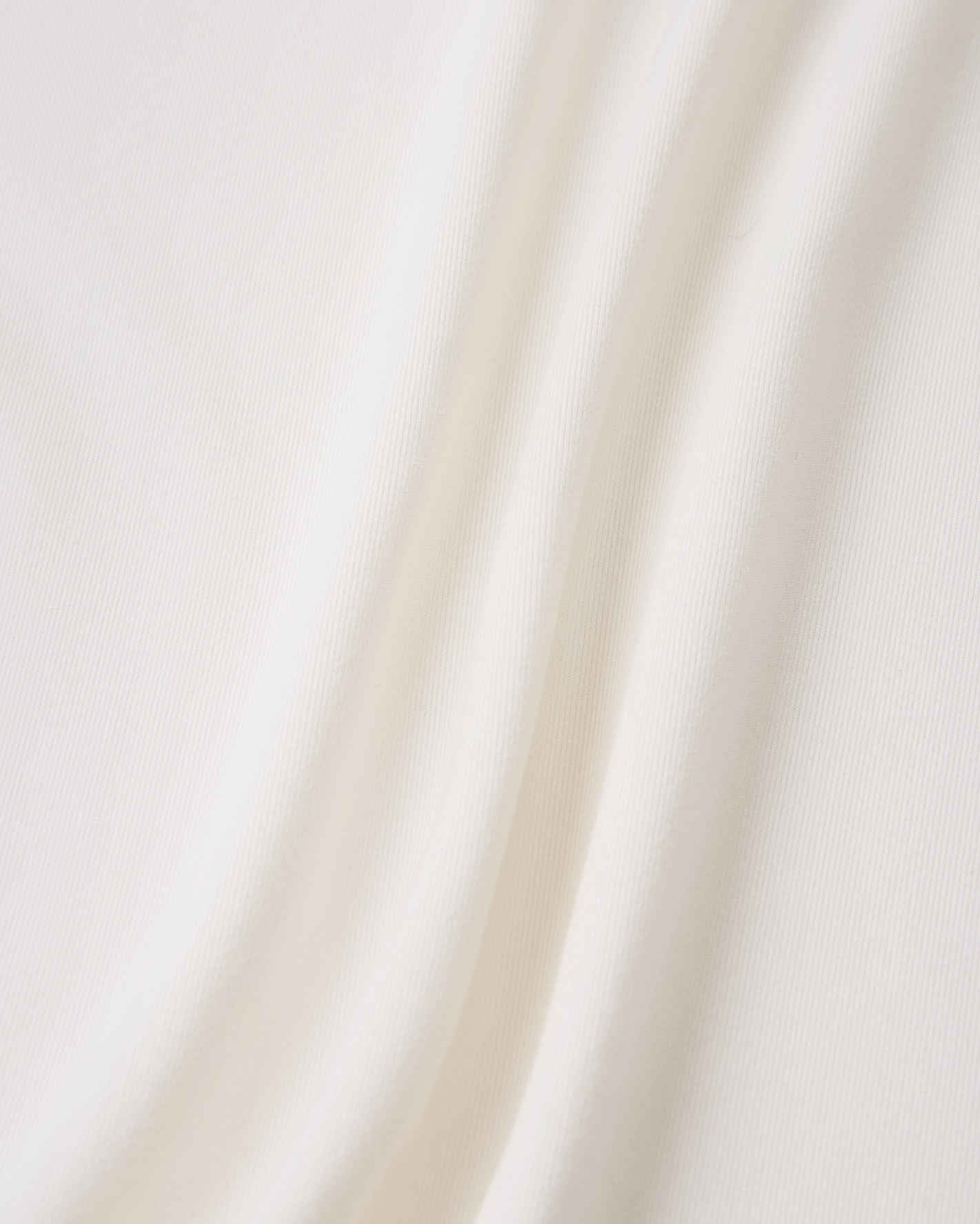 Close-up detail of the smooth, off-white fabric on the Reima Vauhdikas kids' summer t-shirt, engineered specifically for a cooling effect and enhanced breathability during active wear.