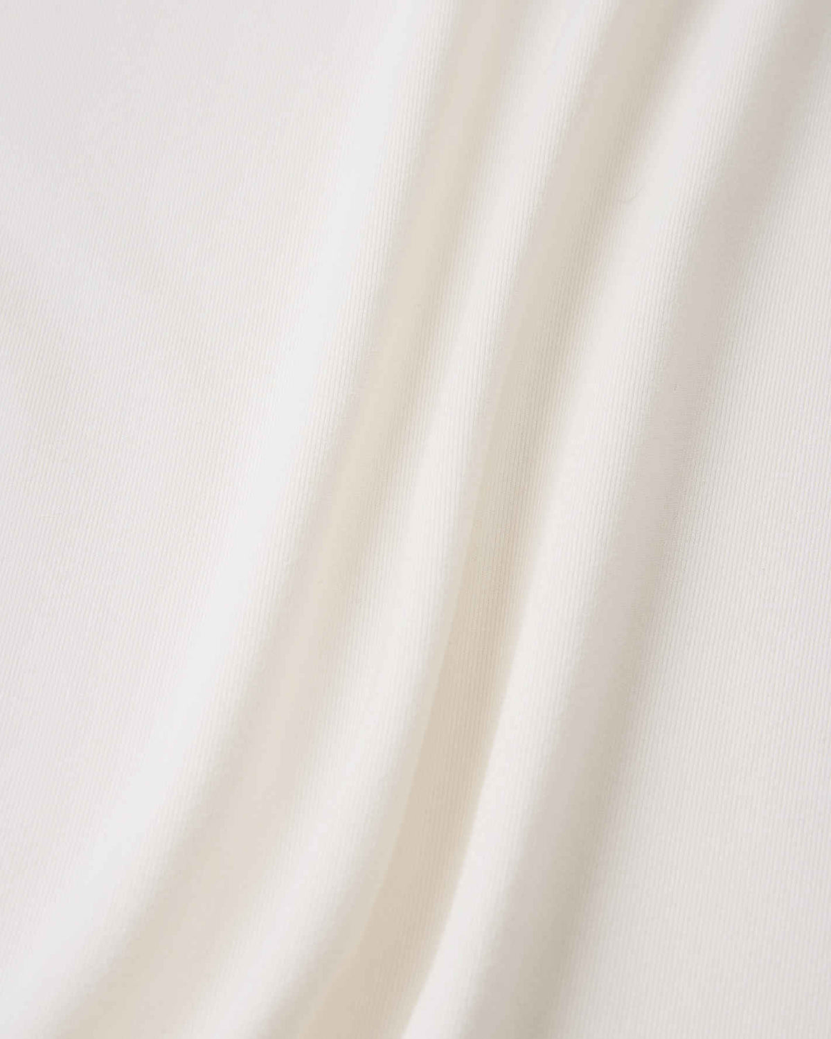 Close-up detail of the smooth, off-white fabric on the Reima Vauhdikas kids' summer t-shirt, engineered specifically for a cooling effect and enhanced breathability during active wear.
