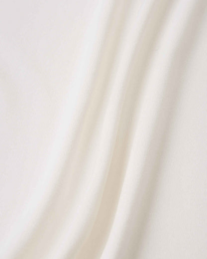 Close-up detail of the smooth, off-white fabric on the Reima Vauhdikas kids' summer t-shirt, engineered specifically for a cooling effect and enhanced breathability during active wear.