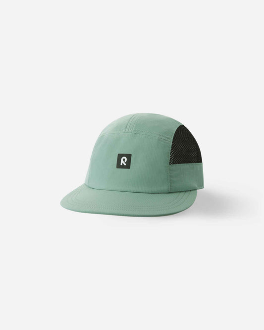 Front view of the Reima Verkot kids' UPF 50+ summer sun cap in stone green, featuring contrasting black breathable mesh side panels and a central black Reima logo patch.