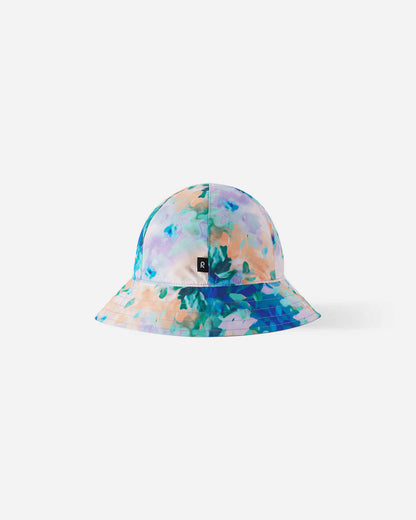 Back view of the fresh blue Reima Viiri kids' reversible sunhat, highlighting the continuous pastel floral pattern, black Reima logo tag, and lightweight, breathable sunproof fabric.