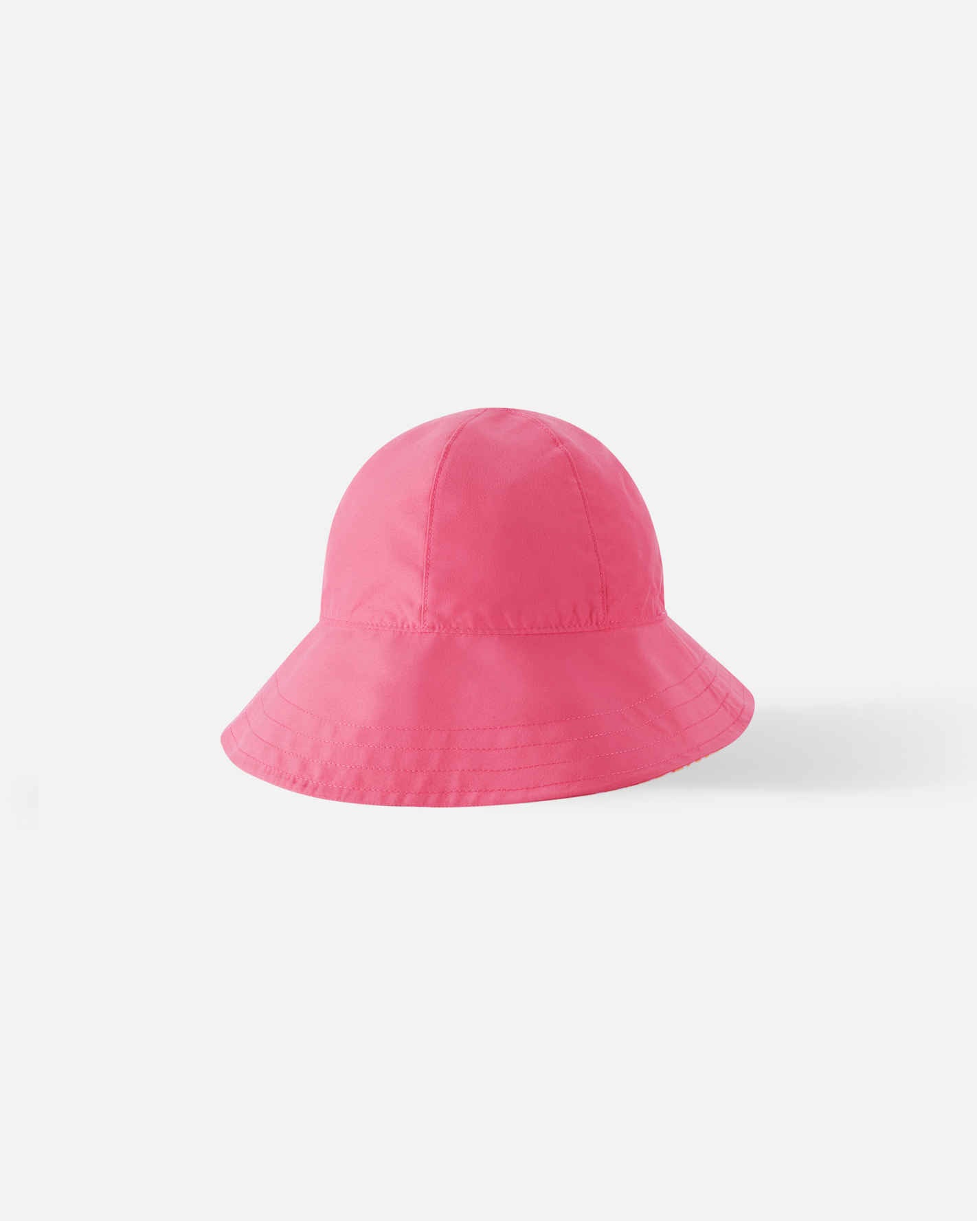 Reverse side of the Reima Viiri kids' soft coral sunhat, showing a solid bright pink colorway on the classic bucket hat silhouette, providing two stylish looks in one UPF 50+ accessory.
